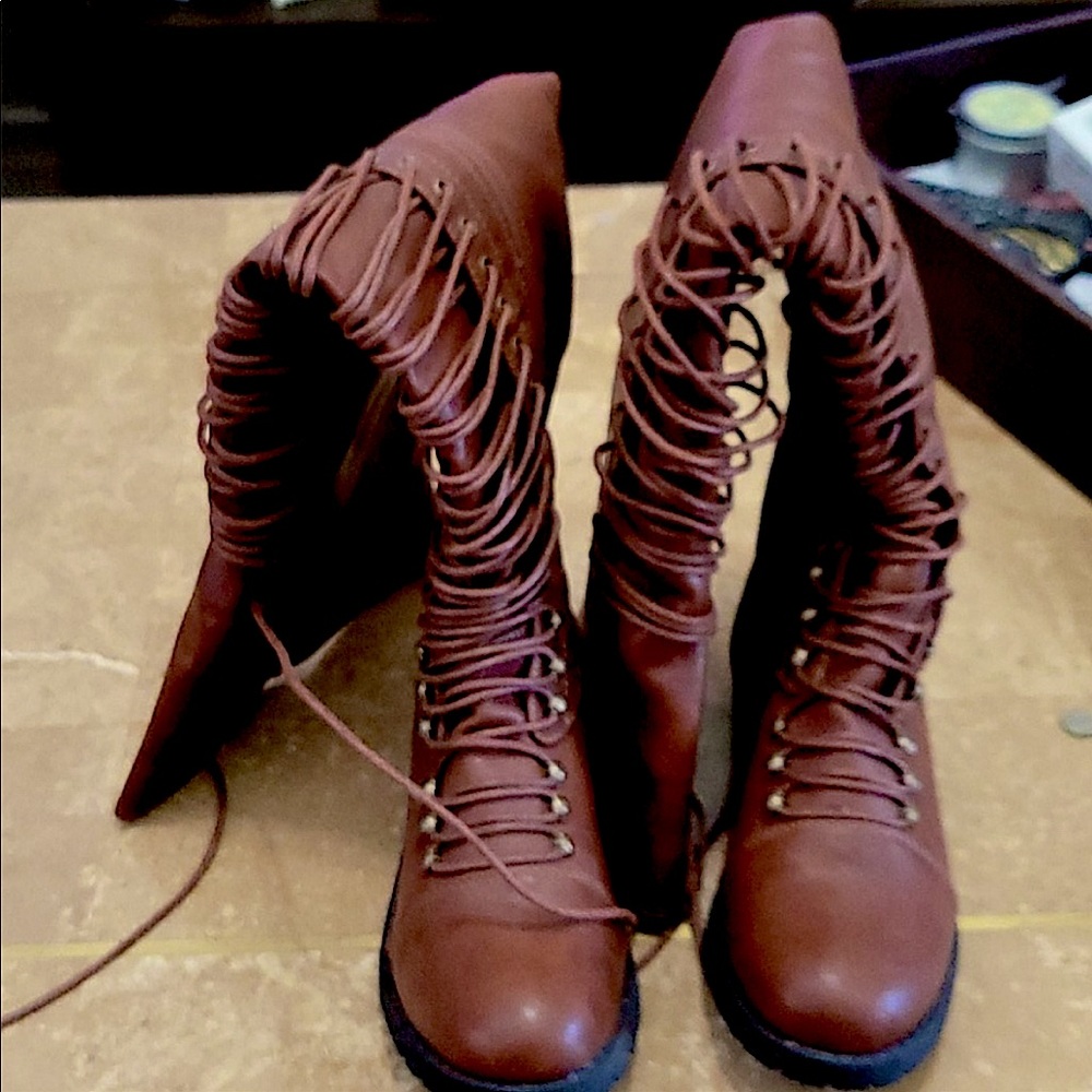Brown above the knee lace up boots with zipper on the side.